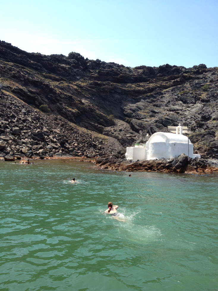 Swimmers brave the cold Aegean waters en route to the volcano's warm springs
